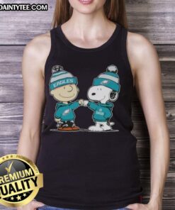 Cute Peanuts Charlie Brown fist bumping Snoopy in Philadelphia Eagles football tank top, perfect for fans.