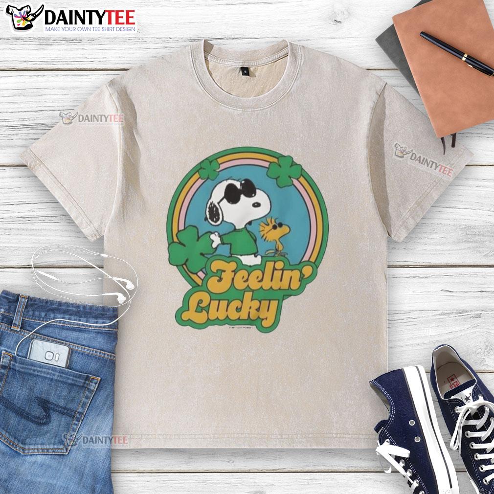 cute-peanuts-shamrock-feeling-lucky-washed-t-shirt Alt Text: Cute Peanuts Shamrock Feeling Lucky washed t-shirt featuring Charlie Brown and Snoopy in festive green design.