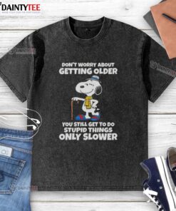 Cute Snoopy graphic on a washed t-shirt with a humorous quote about aging and doing silly things, perfect for casual wear.