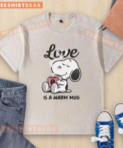Alt Text: Cute Snoopy love is a warm mug design on a stylish washed T-shirt, perfect for fans of Peanuts and cozy attire.