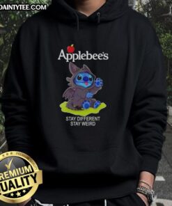 Adorable Stitch cosplay wearing a Toothless X Applebee's hoodie with 'Stay Different, Stay Weird' slogan.