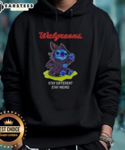 Adorable Stitch cosplay wearing a Toothless X Walgreens hoodie with 'Stay Different, Stay Weird' slogan.