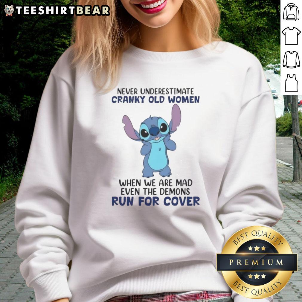cute-stitch-never-underestimate-cranky-old-women-when-we-are-mad-even-the-demons-run-for-cover-sweatshirt Cute Stitch sweatshirt with quote about cranky old women scaring demons, perfect for humorous gift ideas.