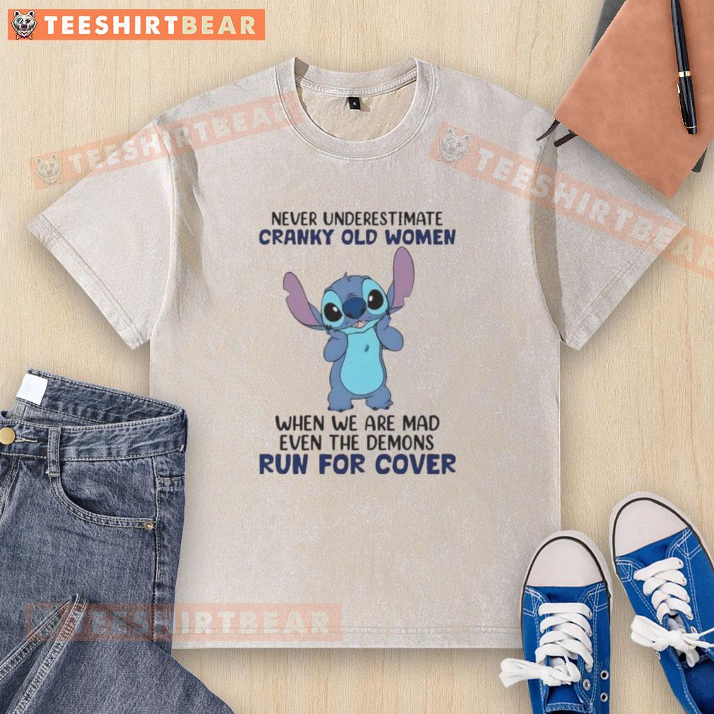 cute-stitch-never-underestimate-cranky-old-women-when-we-are-mad-even-the-demons-run-for-cover-washed-t-shirt Alt Text: Cute Stitch design on a washed t-shirt with 'Never underestimate cranky old women' quote, perfect for fierce grandmas.