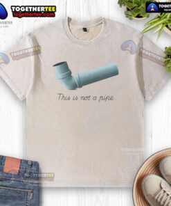 Funny 'This Is Not A Pipe' meme printed on a washed t-shirt, showcasing a humorous art twist in casual wear.