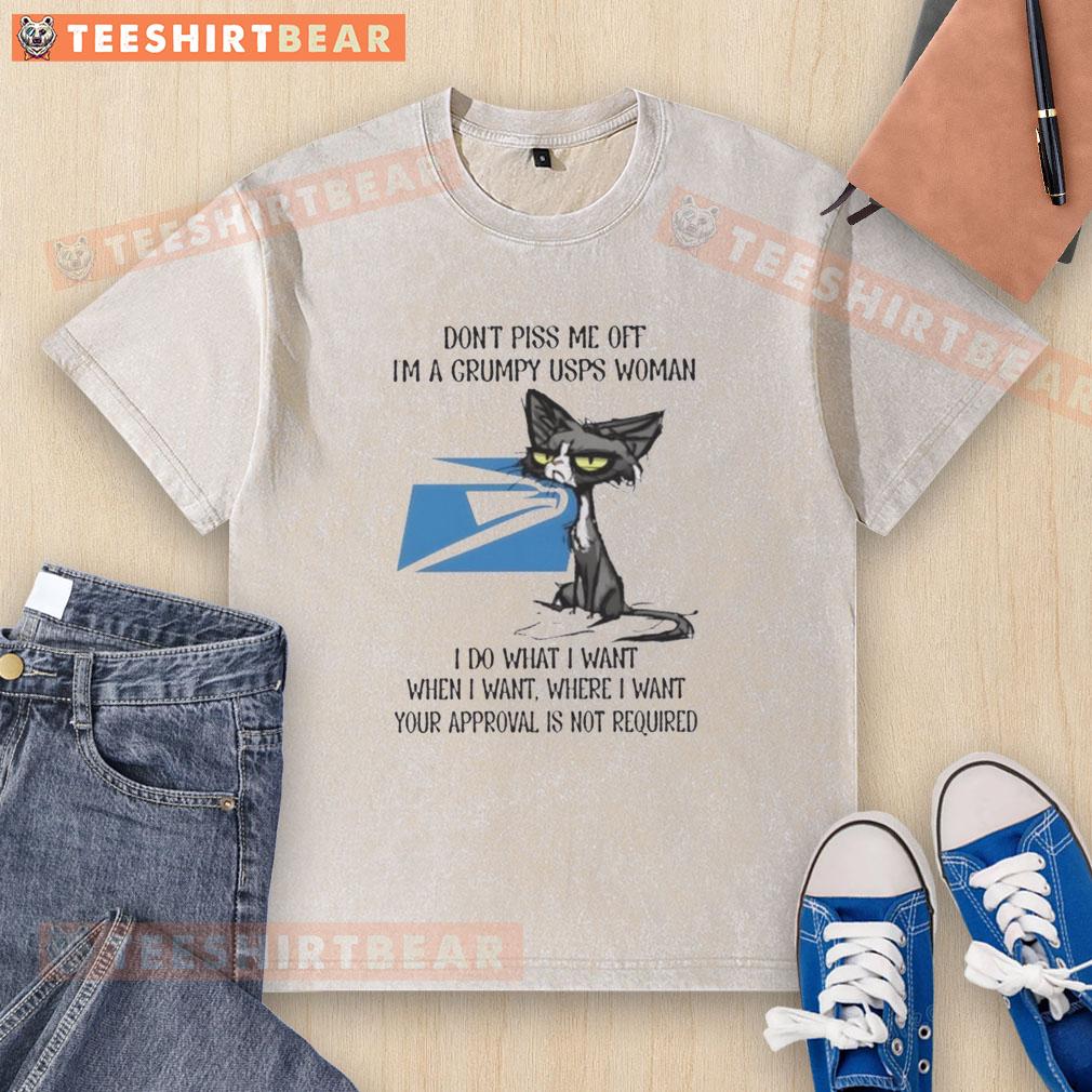 funny-tired-cat-dont-piss-me-off-im-a-grumpy-usps-woman-i-do-what-i-want-washed-t-shirt Alt Text: Grumpy cat wearing a Don't Piss Me Off USPS shirt, showcasing a funny and tired expression. Perfect for cat lovers!