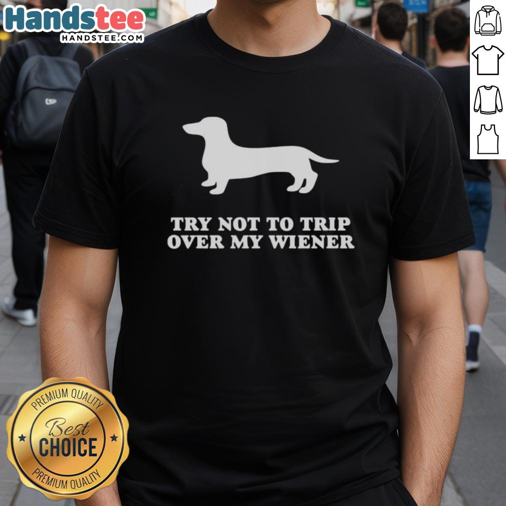 funny-try-not-to-trip-over-my-wiener-t-shirt-1 Alt Text: Funny Try Not To Trip Over My Wiener T-Shirt featuring a playful dog graphic, perfect for dog lovers and humor enthusiasts.