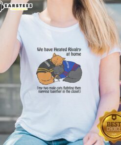 Two male cats playfully fighting and then napping together in a closet, showcasing their funny rivalry at home.