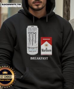Good breakfast featuring a white monster energy drink, Marlboro Red cigarette, and stylish hoodie on a table.