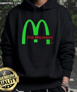 Charli XCX wearing the Good Charli XCX The Moment Hoodie, showcasing a stylish and trendy streetwear look.