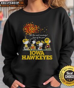 Alt Text: Good Charlie Brown sweatshirt featuring Sally Brown, Snoopy, and Woodstock with Iowa Hawkeyes theme for the holidays.