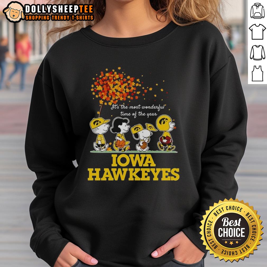 Good Charlie Brown Sally Brown Snoopy Woodstock Iowa Hawkeyes It's The Most Wonderful Time Of The Year Sweatshirt Alt Text: Good Charlie Brown sweatshirt featuring Sally Brown, Snoopy, and Woodstock with Iowa Hawkeyes theme for the holidays.