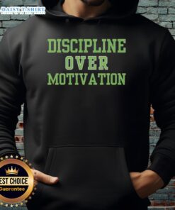 Person wearing a 'Good Discipline Over Motivation' hoodie during a gym workout, showcasing consistency and dedication.