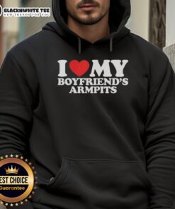 Person wearing a red heart hoodie that says 'Good I Love My Boyfriend's Armpits' in a cozy setting.