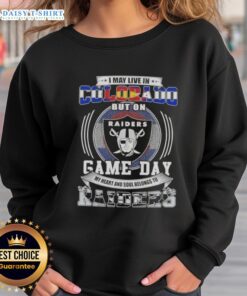 Cozy sweatshirt featuring 'Good I May Live in Colorado But My Heart Belongs to Las Vegas Raiders' for passionate fans.