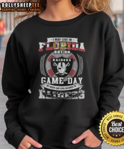 Florida fan wearing a Las Vegas Raiders football sweatshirt, showcasing team spirit on game day.