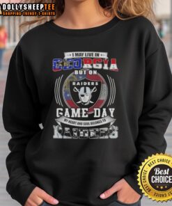 Cozy sweatshirt featuring 'Good I May Live In Georgia But On Game Day My Heart Belongs To Las Vegas Raiders' design.
