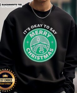 Good It's Okay To Say Merry Christmas logo sweatshirt featuring festive design, perfect for holiday celebrations.