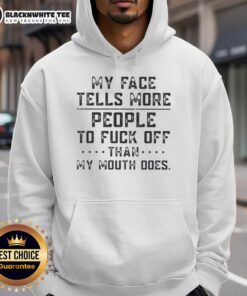 Alt Text: Person wearing 'Good My Face Tells More People To Fk Off Than My Mouth Does' hoodie, showcasing bold graphic design.