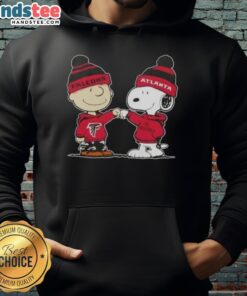 Alt Text: Charlie Brown and Snoopy fist bump in Atlanta Falcons hoodie, showcasing Good Peanuts collaboration and football spirit.