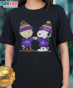 Peanuts Charlie Brown fist bump with Snoopy on a Baltimore Ravens football ladies tee, perfect for fans.