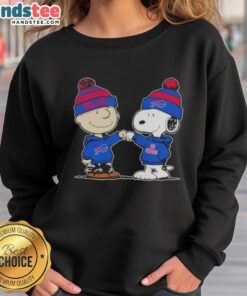 Charlie Brown and Snoopy fist bump in a Buffalo Bills football sweatshirt, celebrating friendship and team spirit.