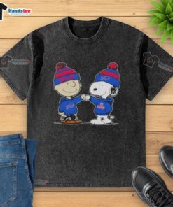Charlie Brown fist bumps Snoopy in a Buffalo Bills football washed t-shirt, celebrating friendship and sports spirit.
