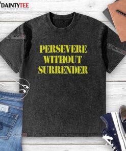 Good Persevere Without Surrender washed t-shirt displayed on a wooden surface, showcasing its unique design and soft fabric.