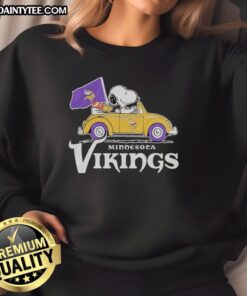 Alt Text: Good Snoopy and Woodstock riding in a Minnesota Vikings football car logo sweatshirt, showcasing team spirit.