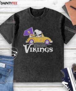 Alt Text: Good Snoopy and Woodstock riding a Minnesota Vikings football car logo on a washed t-shirt, perfect for fans.