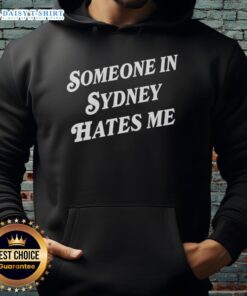 Alt Text: Cozy 'Good Someone In Sydney Hates Me' hoodie displayed against a vibrant urban backdrop, perfect for casual wear.