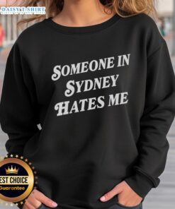 Cozy 'Good Someone in Sydney Hates Me' sweatshirt displayed on a hanger, perfect for casual wear and unique style.