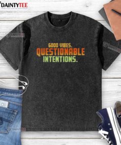 Alt Text: Trendy Good Vibes Questionable Intentions washed t-shirt displayed on a wooden background, perfect for casual outfits.