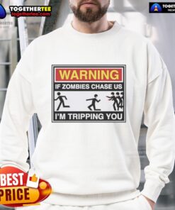 Good Warning If Zombies Chase Us I'm Tripping You Sweatshirt featuring a humorous zombie-themed design for Halloween.