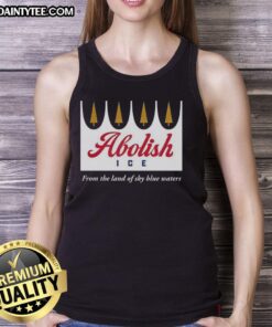 Happy abolitionist wearing a 'Abolish ICE' tank top against a backdrop of blue waters, promoting social justice and awareness.