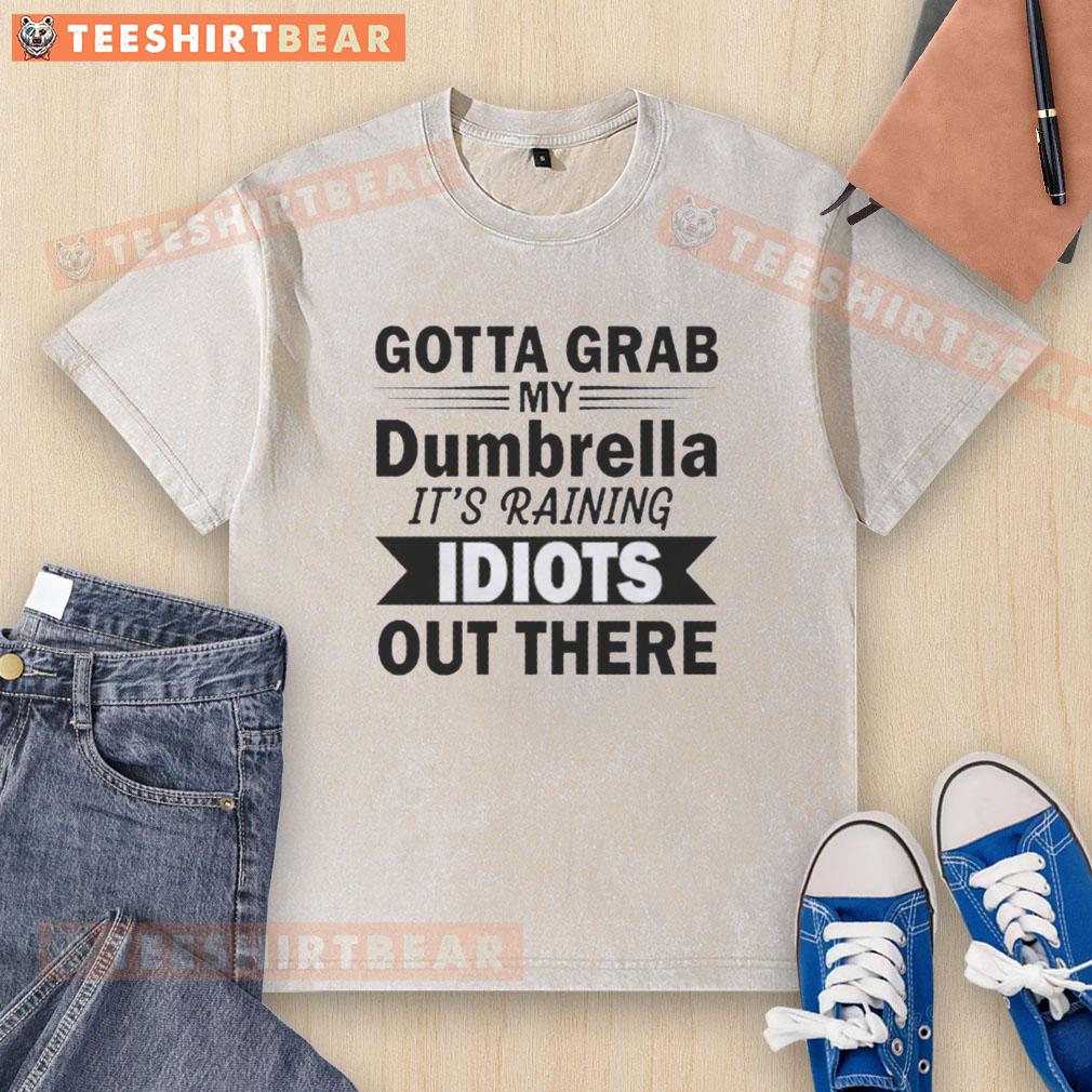 hot-gotta-grab-my-dumbrella-its-raining-idiots-out-there-quote-washed-t-shirt Alt Text: Funny washed t-shirt featuring 'Hot, Gotta Grab My Dumbrella, It's Raining Idiots Out There' quote design.