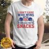 Alt Text: NFL T-shirt featuring 'I Don't Care Who Wins, I'm Just Here for the Snacks' with two helmets and IDC logo.