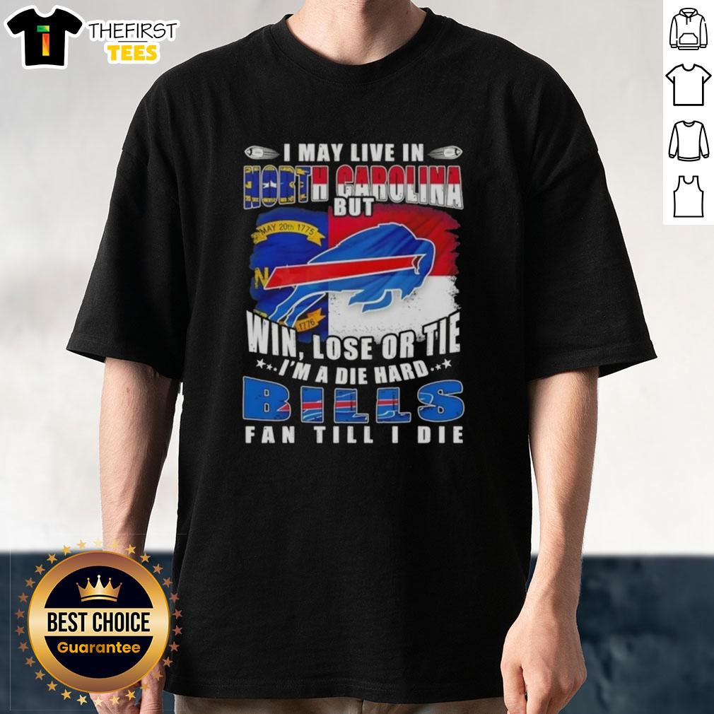 hot-i-may-live-in-north-carolina-but-win-lose-or-tie-im-a-die-hard-buffalo-bills-fan-till-i-die-t-shirt-1 Alt Text: Buffalo Bills fan t-shirt with text 'Hot I May Live In North Carolina But Win Lose Or Tie Im A Die Hard' design.