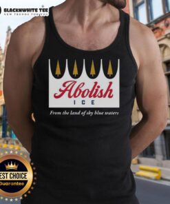 Model wearing a 'Nice Abolish Ice From The Land of Sky Blue Waters' tank top, showcasing a bold, impactful design.
