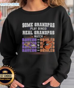 Funny sweatshirt featuring Baltimore Ravens and Orioles theme: 'Real Grandmas Watch' perfect for sports-loving grandmas.