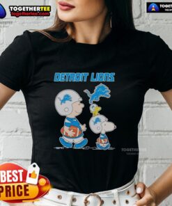 Detroit Lions ladies tee featuring Snoopy and Charlie Brown, perfect for fans of the NFL and the Detroit Lions.