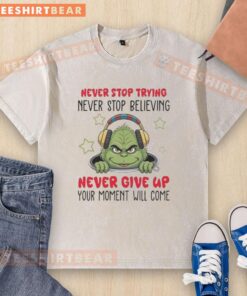 Alt Text: Nice Grinch Never Stop Trying Never Stop Believing washed t-shirt featuring a festive Grinch design and motivational text.