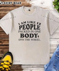 Colorful washed t-shirt featuring 'Nice, I am like 12 people packed in one body' spin the wheel quote design.