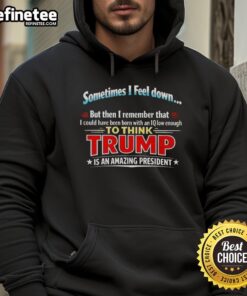 Person wearing a humorous 'I Could Have Been Born With An IQ Low Enough To Think Trump' hoodie, showcasing political satire.