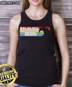 Woman wearing a 'Nice I Love Rehoboth Beach Delaware' tank top by the Atlantic Ocean, showcasing beach vibes.