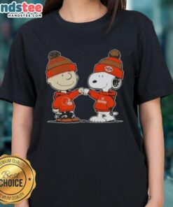 Charlie Brown and Snoopy fist bump in Cleveland Browns gear on a ladies tee, celebrating friendship and football fun.