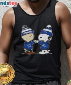 Charlie Brown fist bumps Snoopy in a Dallas Cowboys football tank top, showcasing Nice Peanuts fan apparel.