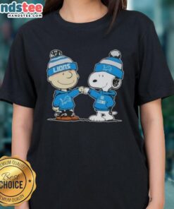 Charlie Brown and Snoopy fist bump in Detroit Lions ladies tee featuring nice peanuts design for football fans.