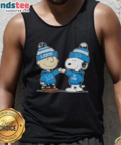Charlie Brown and Snoopy fist bump in a Detroit Lions football tank top, featuring nice peanuts design.