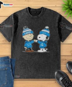 Charlie Brown and Snoopy fist bump in a washed t-shirt featuring Detroit Lions football design, perfect for fans.